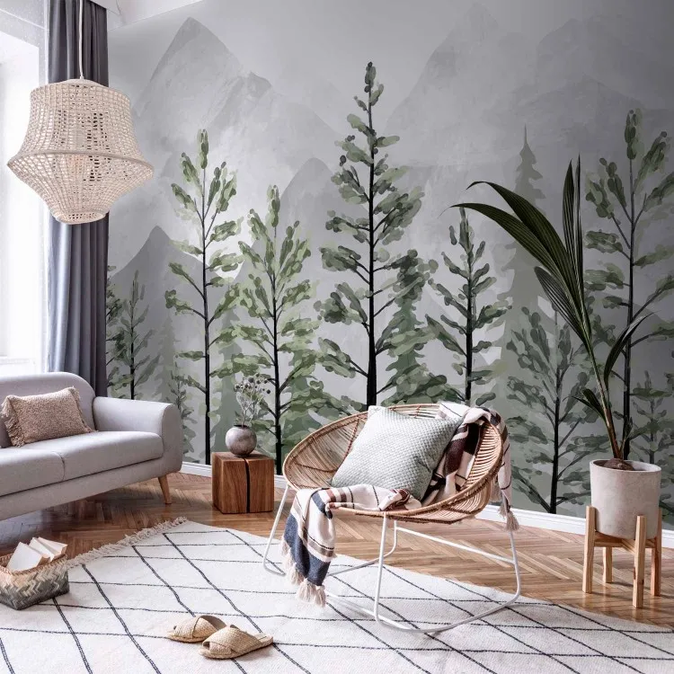 Paysage montagneux - grands arbres verts sur fond de montagnes grises